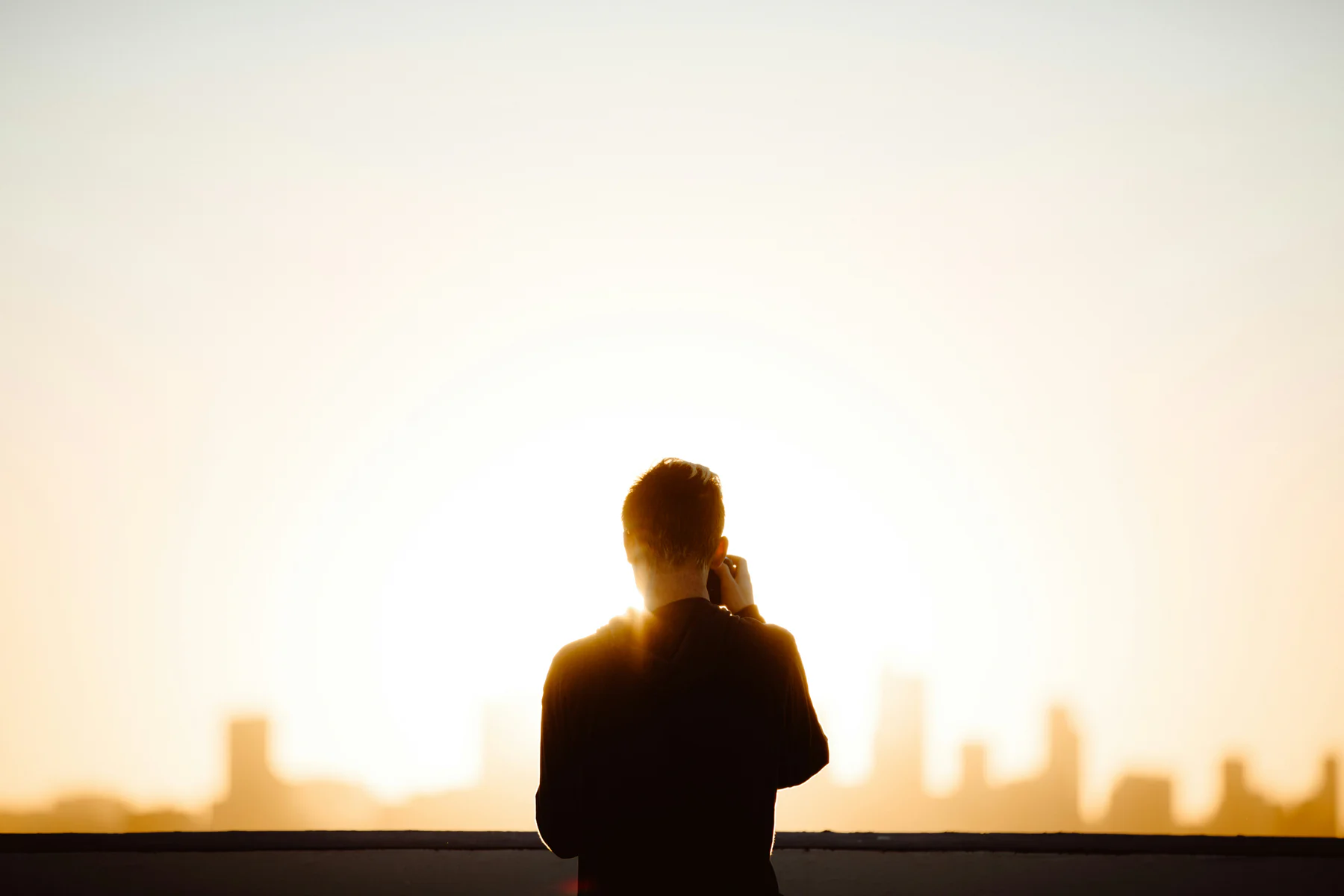 A caller silhouetted against the evening sky
