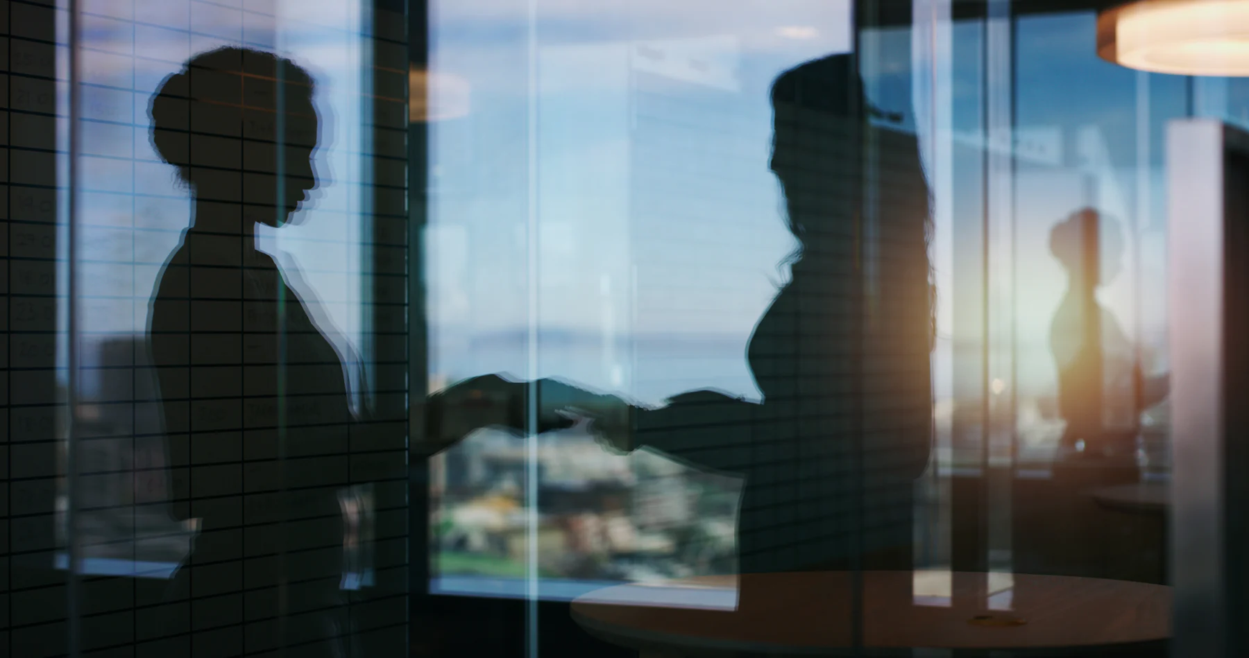 Colleagues having a conversation in a bright office